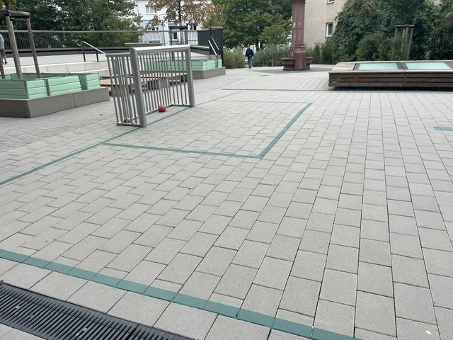 Frisch markiertes Fußballfeld mit Tor auf dem gepflasterten Schulhof der Mühlbergschule