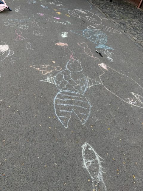 Mit Kreide gemalte Fische und Meerestiere auf dem Asphalt neben den Fischerhallen Frankfurt